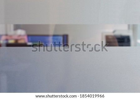 Abstract blurred image of closeup decorative glass film office. Frosted film glass sticker. Toilet wall sticker bathroom decoration. Office films privacy for bathroom Office meeting room.