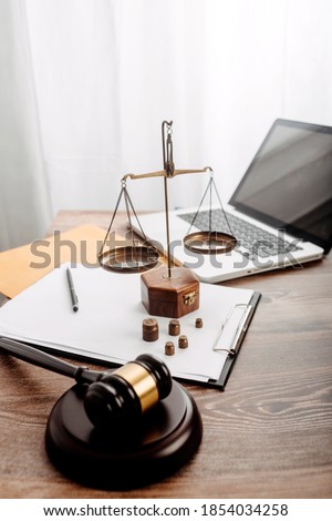 Business and lawyers discussing contract papers with brass scale on desk in office. Law, legal services, advice, justice and law concept picture with film grain effect Royalty-Free Stock Photo #1854034258