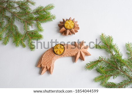 Christmas decoration 
carved from linden wood. Handmade carved wooden star and comet. Beeswax candles.