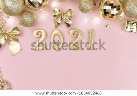 New year 2021 Golden numbers in the design of the Golden Christmas decor on a pink background