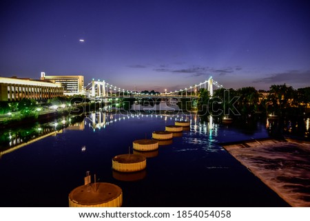 city and bridge lights at night along the river