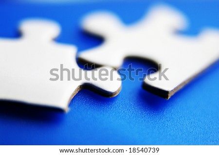 closeup of two puzzle pieces fitting together