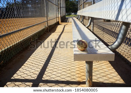 Baseball on bench in dugout                               
