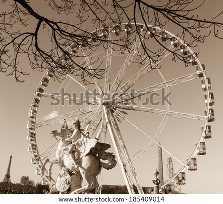 Horseman statue. Ferris wheel and Eiffel tower at background. Paris, France. Aged photo. Sepia.