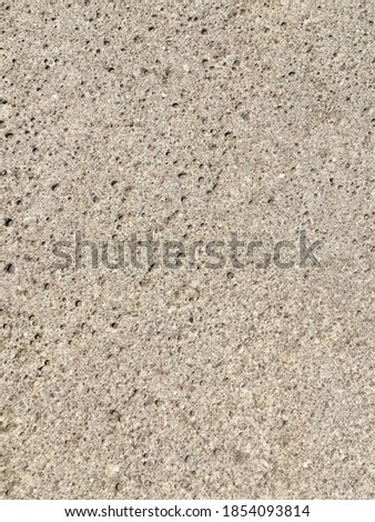 Gray textured porous wall. Abstract stone texture. Minimalistic background.