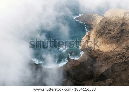 Flying over a scenic landscape, cliffs and ocean in a remote volcanic landscape of Tenerife, Canary Islands. High quality photography.