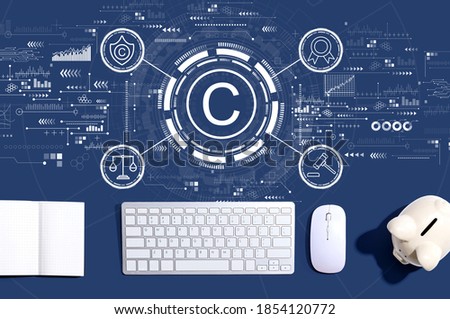 Copyright concept with a computer keyboard and a piggy bank