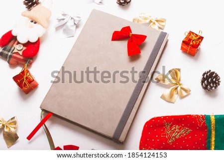 A nice picture of a journal near some christmas decorations