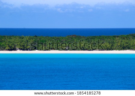 Ocean and beach panorama with palm trees and sand