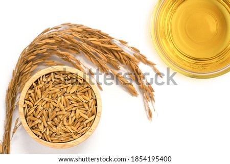 Rice bran oil extract with paddy unmilled rice on white background. Top view. Flat lay. Royalty-Free Stock Photo #1854195400