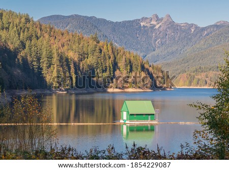 Beautiful autumn landscape of the boathouse at Cleveland Dam reservoir near North Vancouver, BC/Canada-November 8,2020. Travel photo, street view, selective focus.