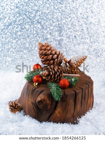 Christmas decoration greeting card - cones on a fir branch with Christmas lights.On a snowy background