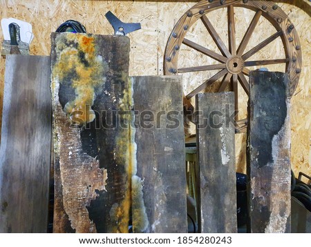 barn interior as a beautiful background. bog oak boards covered with mold, wooden wheel, wall of pressed sawdust. closet
