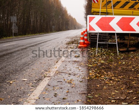 detour sign on the right. special equipment on the side of the road. temporary road signs on the road. repair of roads.