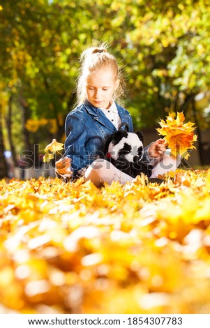 Portrait of a young girl in an autumn park