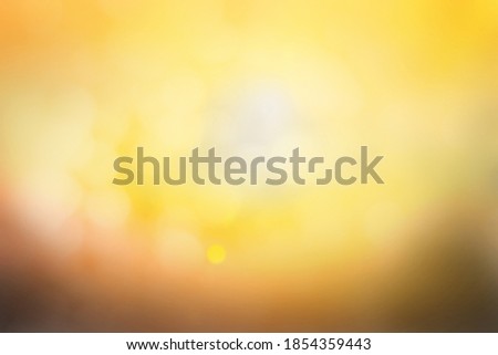 Hope concept; Abstract blurred sunrise background blurring warm colors calm bright sunlight. Sky effect gradient white sun at color orange light yellow soft flare patterns blur plain morning summer.