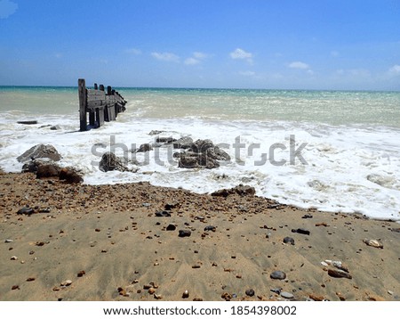Wooden breakwater and rough sea