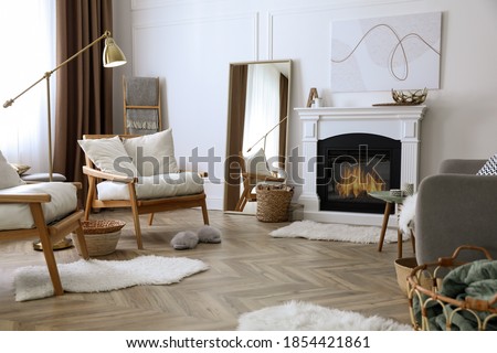 Beautiful living room interior with fireplace and armchairs Royalty-Free Stock Photo #1854421861