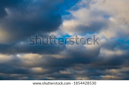 blue sky with gray clouds in sunset time, late autumn