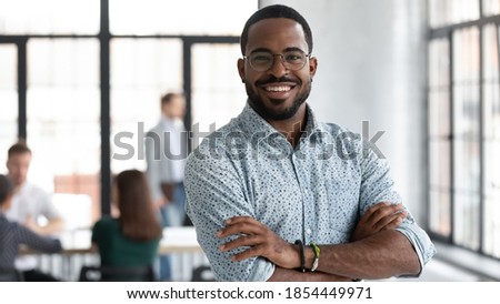 I made this! Portrait of ambitious confident black leader ceo standing with arms crossed on chest at office of successful profitable company looking at camera proud of his achievement career wellbeing