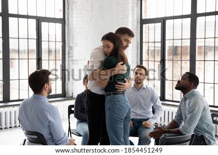 Embraces of support. Sad young male and female patients of psychologist or rehabilitation center hugging one another with understanding and care on group therapy session sharing hard feelings pressure Royalty-Free Stock Photo #1854451249