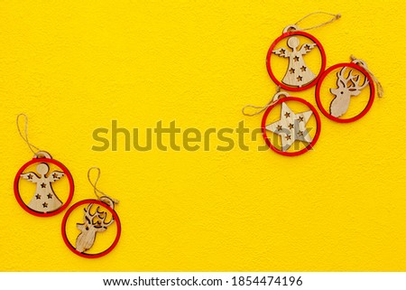 Spruce branch, cones and vintage toys decoration on christmas or new year on yellow background