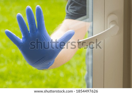 a man in gloves trying to get into the apartment.