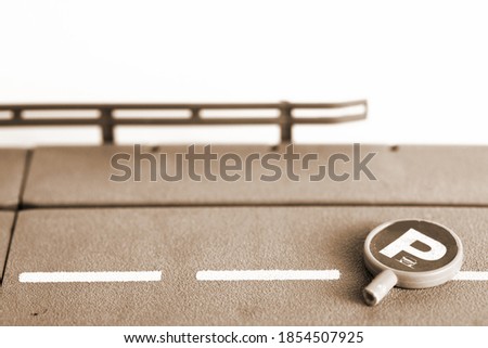 Miniature traffic signage put on the road plate model scene represent road safety concept idea.