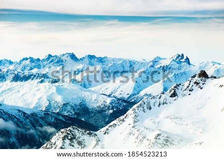 Panoramic view of snow-covered Alps mountains at sunrise. Val Thorens, 3 Valleys, France. Beautiful winter landscape 