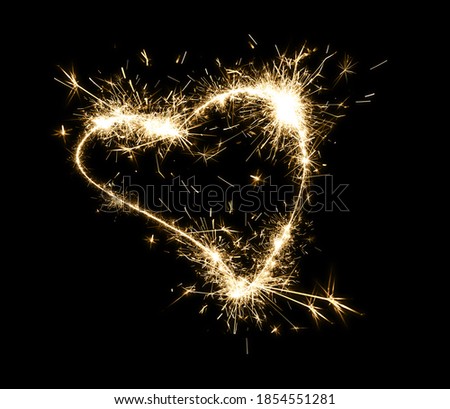 Bright sparkling heart contour on black background 