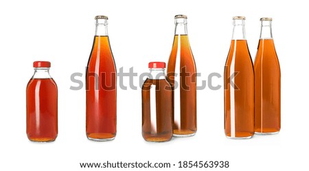 Set with bottles of delicious kvass on white background
