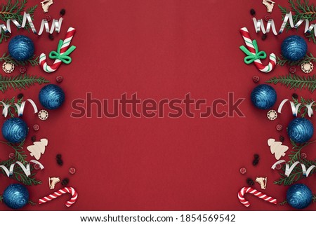 New Year's, festive decor on a red background. Copy space, flat lay, mock up, top view.