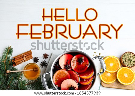 Hello February greeting card. Flat lay composition with delicious mulled wine and ingredients on white wooden table