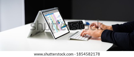 Analyst Employee Using Spreadsheet On Computer Screen