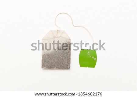 A photograph of a green tea bag, isolated on a white background. Excellent advertising image or for a beverage catalog. Royalty-Free Stock Photo #1854602176