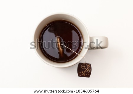 Photograph of a cup of black tea isolated on a white background. Excellent advertising image or for a hot drinks menu. Seen from above. Royalty-Free Stock Photo #1854605764