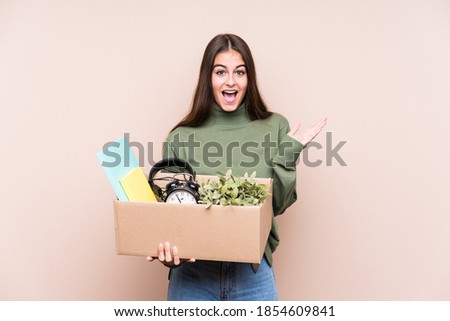 Young caucasian woman moving to a new home isolated surprised and shocked.