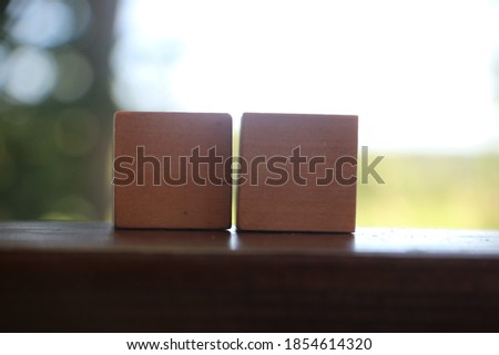 Two wooden cubes on nature background. Desicion making concept in business or career.