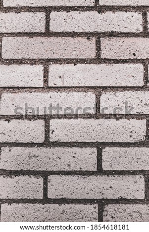 An abstract, old, beige brick wall, can be used as a background