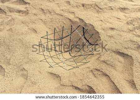a turtle nest on a public beach is enclosed by a metal grate. Responsible attitude and care for endangered species