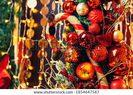 Christmas and New Year holidays bokeh light background with red apple and pine cone.