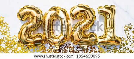 Banner. Happy New year 2021 celebration. Gold and silver foil balloons numeral 2021 and gold confetti on white background. Flat lay.