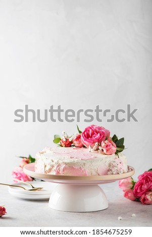 Birthday party concept with rose white cake decorated with pink roses, selective focus image
