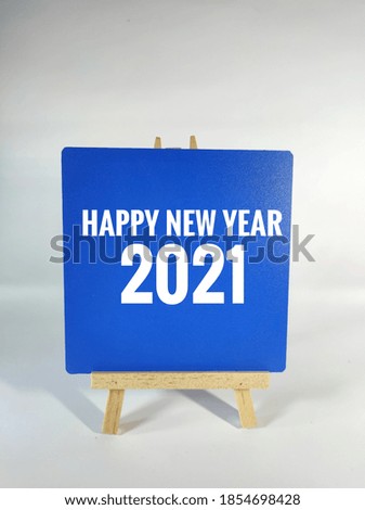 Happy new year 2021 word written on blue board.Isolated on white background.