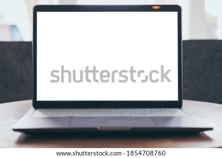 computer blank screen mockup.aptop with white background for advertising,contact business search information on desk at coffee shop.marketing and creative design
