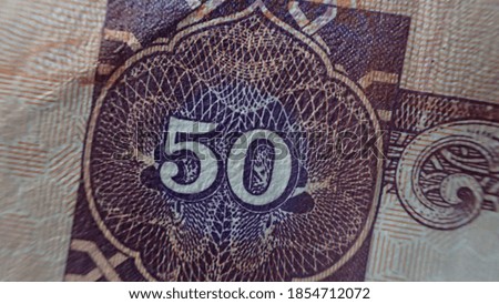 Texture of United Arab Emirates dirhams bills. Fifty dirhams. Close-up, macro.