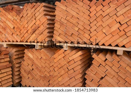 Diagonal stacking in two columns towards the center. wooden pallets with red building bricks stacked on it for transportation