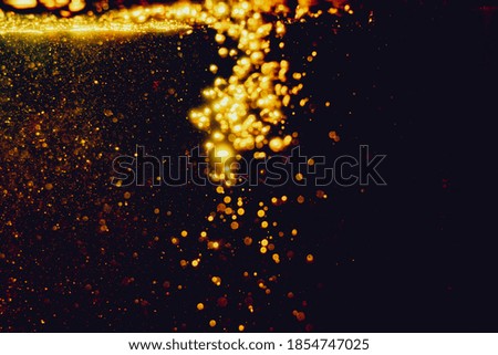 Glittering stars of blur gold  bokeh use for celebrate with black background