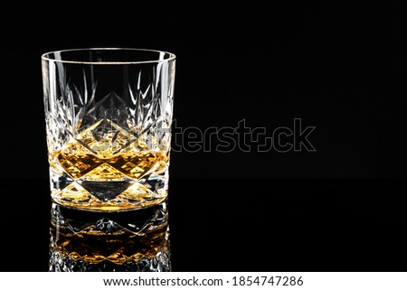Golden scotch whisky on a black background