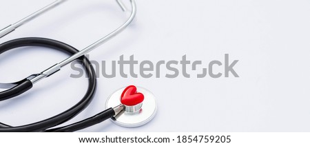 Banner.Creative medical postcard stethoscope and red heart on white background. Medicine flatlay. Royalty-Free Stock Photo #1854759205